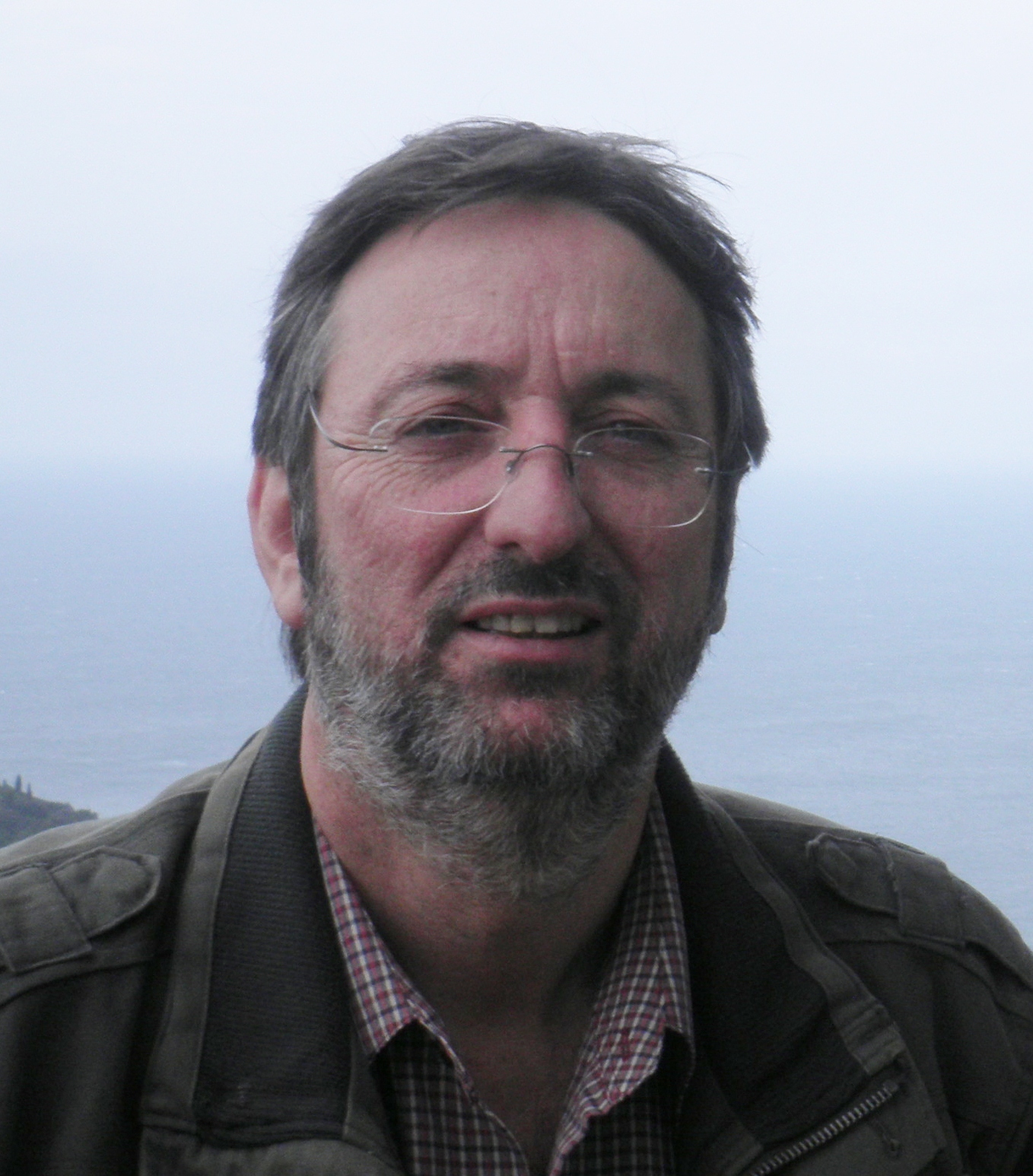 A photograph of David O'Brien, a man who has a short salt-and-pepper beard and wears glasses.