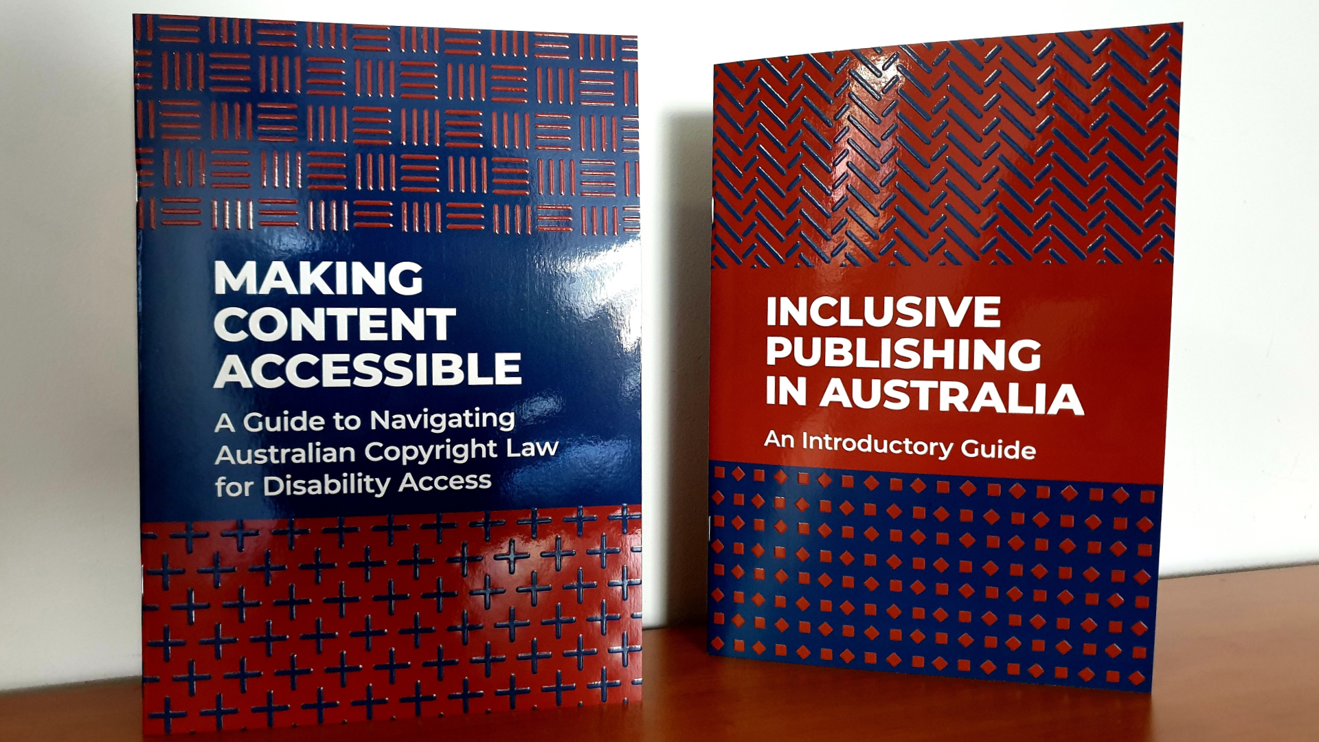 A photo of two Inclusive Publishing guides - Making Content Accessible and Inclusive Publishing in Australia